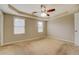 Main bedroom with ceiling fan and neutral carpeting at 1187 Dixie Rd, Covington, GA 30014