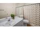 Clean bathroom with white vanity, shower/tub combo, and patterned shower curtain at 5356 Brooke Ridge Dr, Dunwoody, GA 30338