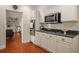 Modern kitchen with white cabinets, gas range, and dark countertops at 5356 Brooke Ridge Dr, Dunwoody, GA 30338