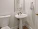 Modern powder room with pedestal sink and tile floor at 5356 Brooke Ridge Dr, Dunwoody, GA 30338