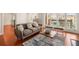 Living room with hardwood floors, gray couch, and access to balcony at 5356 Brooke Ridge Dr, Dunwoody, GA 30338