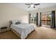 Spacious bedroom with ceiling fan, carpet flooring, and access to balcony at 5356 Brooke Ridge Dr, Dunwoody, GA 30338