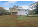 Back of house with deck and grassy yard at 5876 Poplin Ct, Lithonia, GA 30058