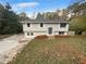 Two story house with gray siding and a manicured lawn at 5876 Poplin Ct, Lithonia, GA 30058