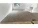Empty living room with neutral gray carpeting at 5876 Poplin Ct, Lithonia, GA 30058