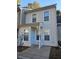 Two-story beige townhome with white trim and landscaping at 6500 Wellington Chase Ct, Lithonia, GA 30058