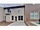 Back of house with patio and partial view of neighboring house at 1192 Kendrew Pass, Marietta, GA 30008