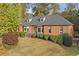 Attractive brick home with gray roof and manicured landscaping at 2545 Winthrope Way, Lawrenceville, GA 30044
