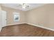 Bright bedroom with wood-look floors and neutral walls at 2545 Winthrope Way, Lawrenceville, GA 30044