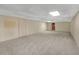 Unfinished basement with neutral carpeting and ample space at 2545 Winthrope Way, Lawrenceville, GA 30044