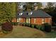 Brick home with gray roof, landscaping, and a walkway leading to the entrance at 2545 Winthrope Way, Lawrenceville, GA 30044