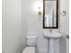 Modern powder room with pedestal sink and elegant wall sconce at 270 17Th Nw St # 1108, Atlanta, GA 30363