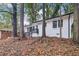 White brick ranch home nestled among trees with autumn leaves at 2804 Dearwood Sw Dr, Atlanta, GA 30315