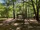 Metal carport structure in a wooded backyard setting at 5618 Highway 212, Covington, GA 30016