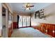 Bedroom with wood paneled walls, ceiling fan and large window at 5618 Highway 212, Covington, GA 30016