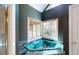 Corner jacuzzi tub with window and green tile at 5618 Highway 212, Covington, GA 30016