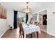 Bright dining room with hardwood floors, chandelier, and view into kitchen at 9154 Branch Valley Way, Roswell, GA 30076