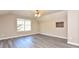Spacious bedroom with hardwood floors and a window at 6315 Wellington Walk Way, Lithonia, GA 30058
