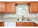 Kitchen features a double sink and wood cabinets at 6315 Wellington Walk Way, Lithonia, GA 30058