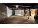 Unfinished basement with stone walls, open space, and garage access at 539 Lynhurst Sw Dr, Atlanta, GA 30311