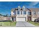 Two-story townhome with attached garage and front yard at 2615 Quarterdeck Dr, Cumming, GA 30041