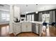 Modern kitchen with white cabinets, island, and stainless steel appliances at 2615 Quarterdeck Dr, Cumming, GA 30041