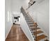 Modern staircase with wooden steps and black railing at 2615 Quarterdeck Dr, Cumming, GA 30041