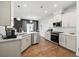 Modern kitchen with white cabinets, stainless steel appliances, and kitchen island at 2615 Quarterdeck Dr, Cumming, GA 30041