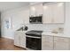 Modern kitchen with white cabinets, stainless steel appliances, and hardwood floors at 2615 Quarterdeck Dr, Cumming, GA 30041