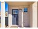 Gray front door with glass panel and brick facade at 2615 Quarterdeck Dr, Cumming, GA 30041