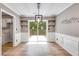 Dining room with sliding glass doors to deck and modern lighting fixture at 4558 Dorsett Shoals Ct, Douglasville, GA 30135