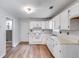 Kitchen with white cabinets, laminate floors and gas range at 4558 Dorsett Shoals Ct, Douglasville, GA 30135