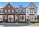 Three-story townhouses with brick and white exteriors at 4219 Tifton Ln, Sugar Hill, GA 30518