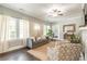 Living room with dark hardwood floors, gray couch, and a ceiling fan at 1847 Walker Ave, College Park, GA 30337