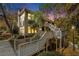 Townhouse exterior at dusk with wooden deck and stairs at 103 Bainbridge Dr, Sandy Springs, GA 30327