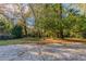 Spacious backyard with mature trees and grassy area at 2301 Delowe Dr, Atlanta, GA 30344