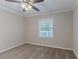 Spacious bedroom with a ceiling fan and large window at 2301 Delowe Dr, Atlanta, GA 30344