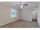 Carpeted bedroom with ceiling fan and access to a bathroom at 2301 Delowe Dr, Atlanta, GA 30344