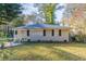 Ranch style home with a well-manicured lawn and mature trees at 2301 Delowe Dr, Atlanta, GA 30344