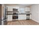 Updated kitchen with stainless steel appliances and white cabinets at 2301 Delowe Dr, Atlanta, GA 30344