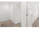 Bright hallway with carpeted floors and doors leading to other rooms at 204 Kenoot Dr, Mcdonough, GA 30253