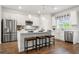 Modern kitchen with island, stainless steel appliances, and white cabinets at 338 Cornett Way, Lawrenceville, GA 30046