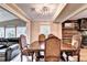 Spacious dining room with elegant wood table and chairs, offering a view of the living area at 4364 Saddlecreek Ct, Auburn, GA 30011