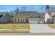 Two-story house with gray siding, stone accents, and a three-car garage at 63 Black Rock Rdg, Sharpsburg, GA 30277
