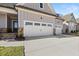 Three-car garage with white doors and stone accents at 63 Black Rock Rdg, Sharpsburg, GA 30277
