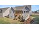Two-story house with gray siding, wooden deck, and stairs at 63 Black Rock Rdg, Sharpsburg, GA 30277