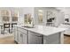 Kitchen island with white quartz countertop and stainless steel dishwasher at 63 Black Rock Rdg, Sharpsburg, GA 30277