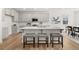 Modern kitchen with gray cabinets, quartz countertops, and an island with seating at 63 Black Rock Rdg, Sharpsburg, GA 30277