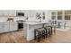 Modern kitchen with gray cabinets, quartz countertops, and an island with seating at 63 Black Rock Rdg, Sharpsburg, GA 30277