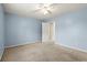 Spacious bedroom with light blue walls and carpet at 902 Callee Dr, Loganville, GA 30052